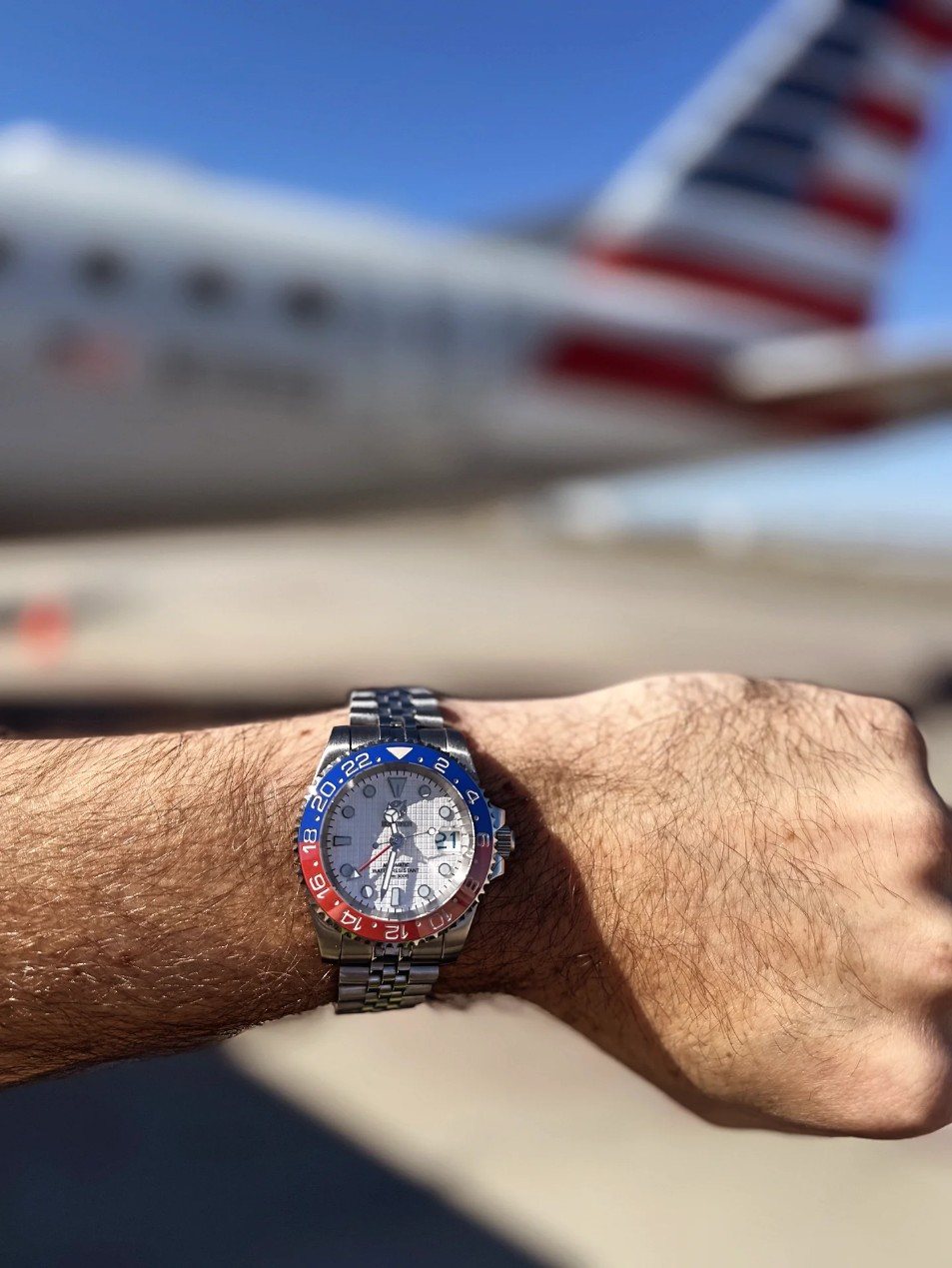 Somerada Pepsi GMT in front of an airliner tail