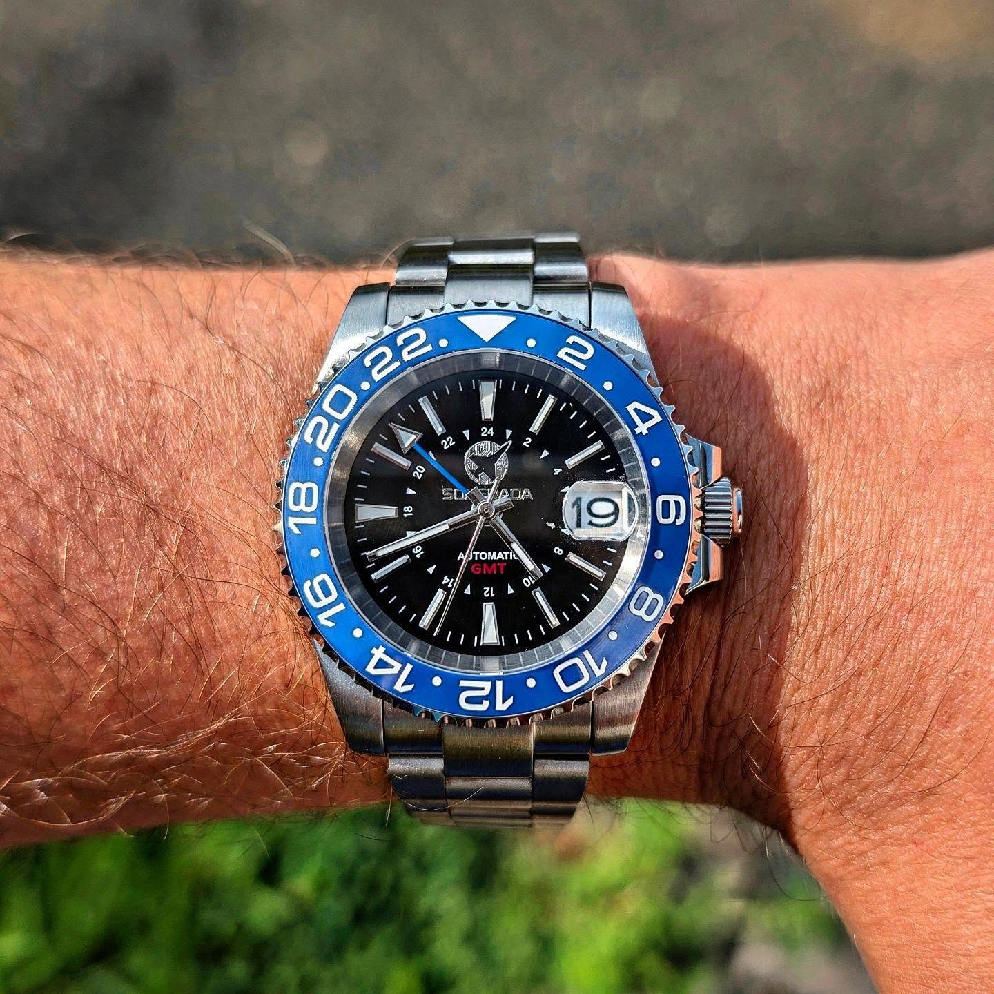 Black dial GMT with blue and black bezel on wrist