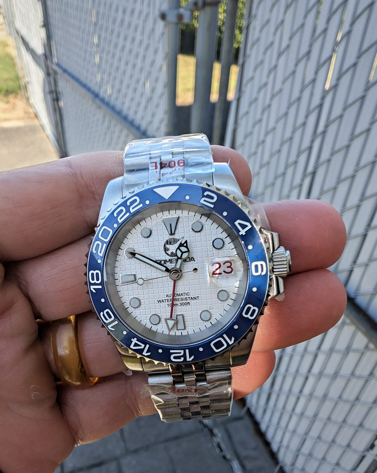 White dial GMT with blue bezel in hand