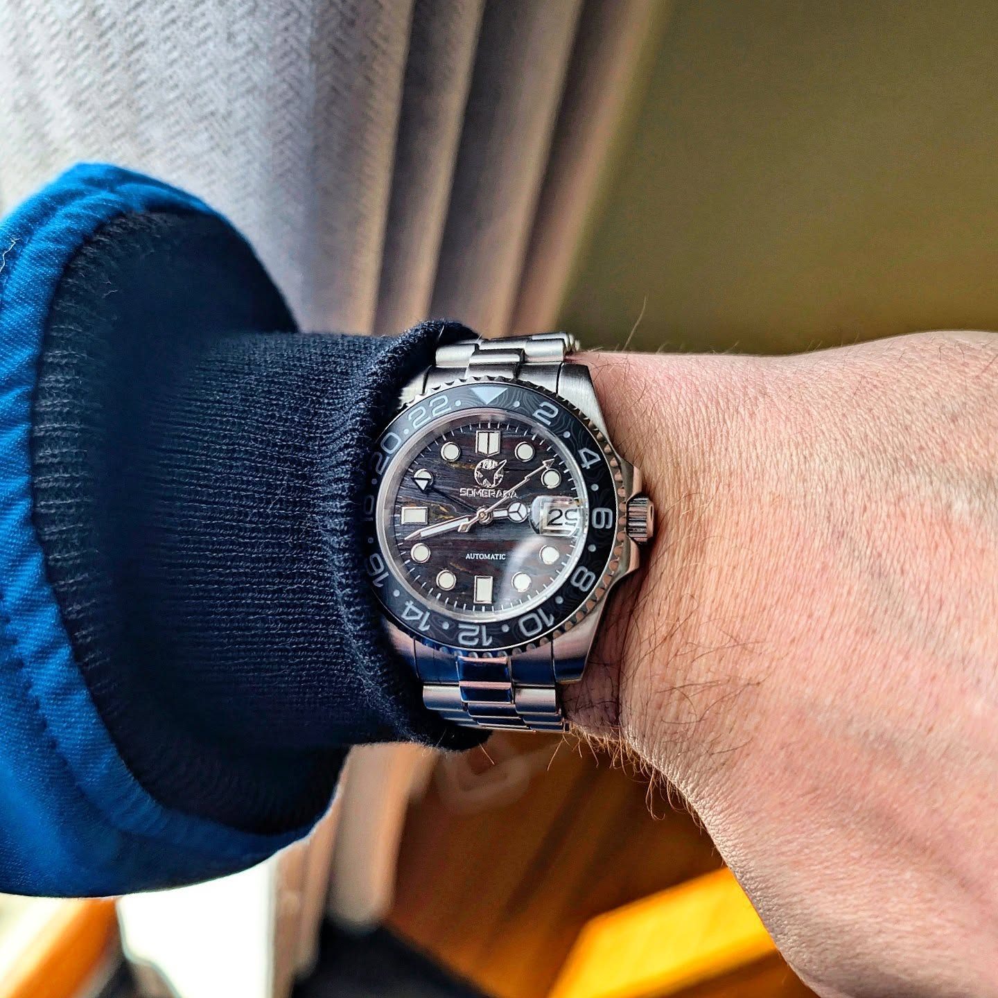 Somerada GMT under a navy sweater cuff