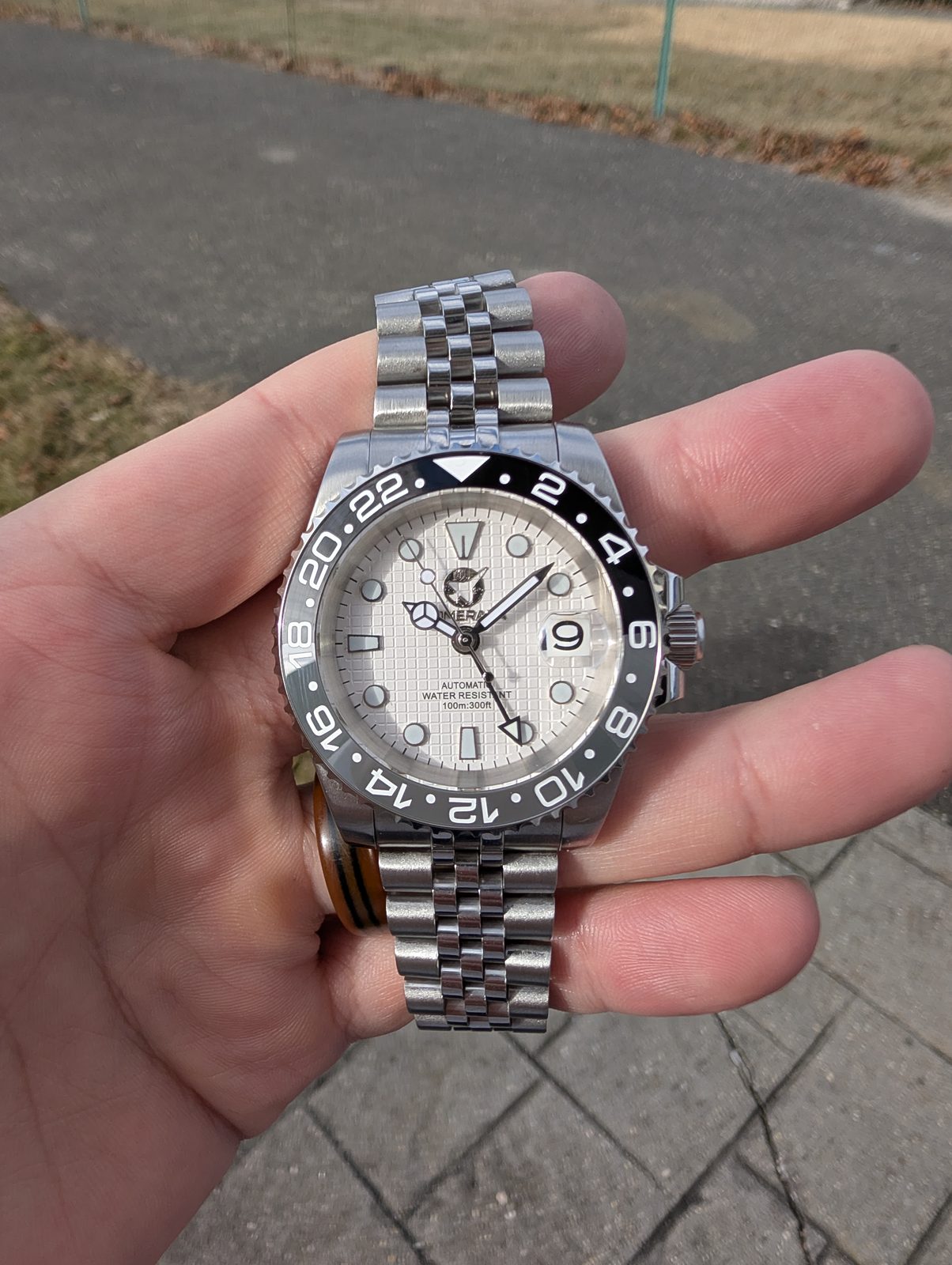 White dial GMT with black bezel and black GMT hand